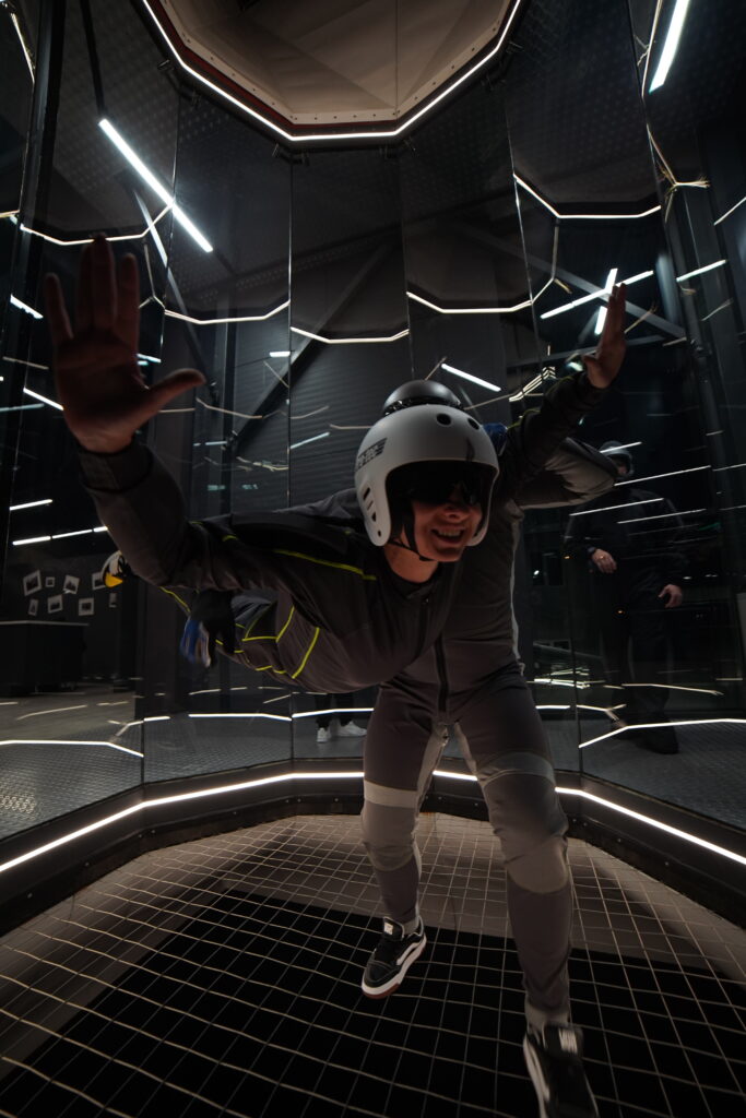 Man in a helmet hovering in the wind tunnel